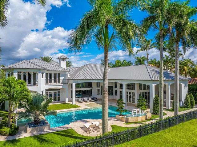 a front view of a house with a yard table and chairs