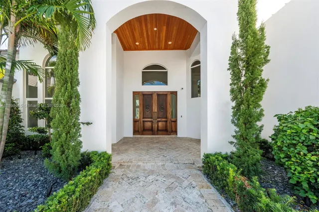 a living room with furniture kitchen view and a potted plant