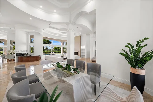 a living room with fireplace furniture and a large window