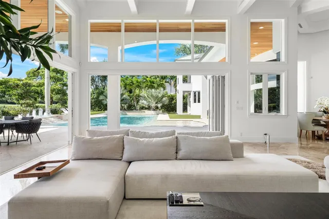 a view of a swimming pool with a patio and a yard