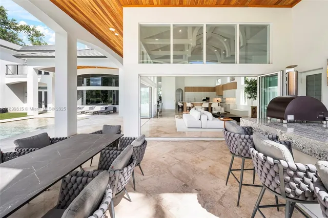 a view of a patio with table and chairs and potted plants