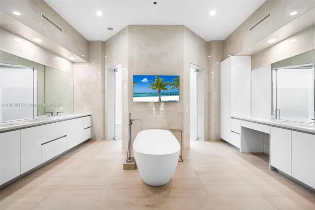 a front view of a house with a yard and potted plants