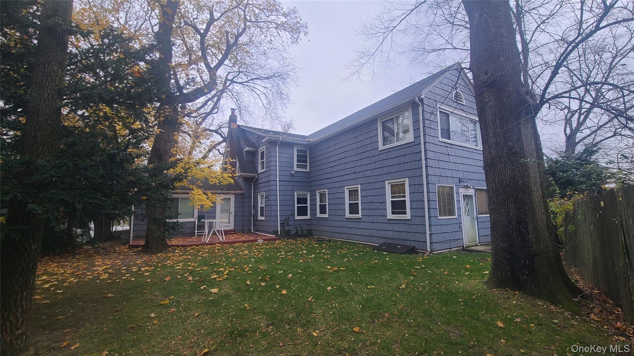 2 Addison Lane Greenvale, NY 11548 - Photo 16 of 18 a brick building with a big yard plants and large trees