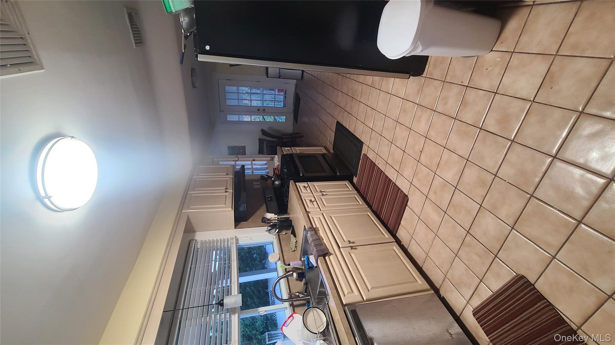 2 Addison Lane Greenvale, NY 11548 - Photo 4 of 18 a kitchen with a sink a stove and a refrigerator