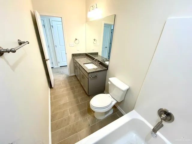 an empty room with a bathroom and a shower