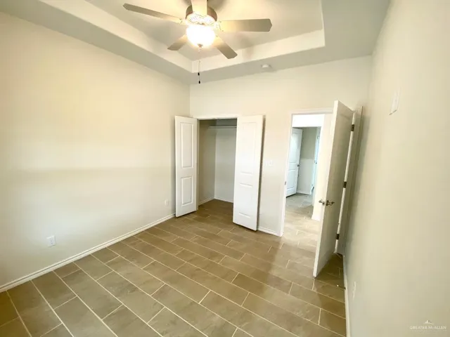 a view of a livingroom with a ceiling fan & a ceiling fan