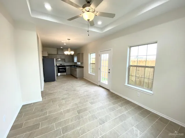 a view of a kitchen with a sink and a large window