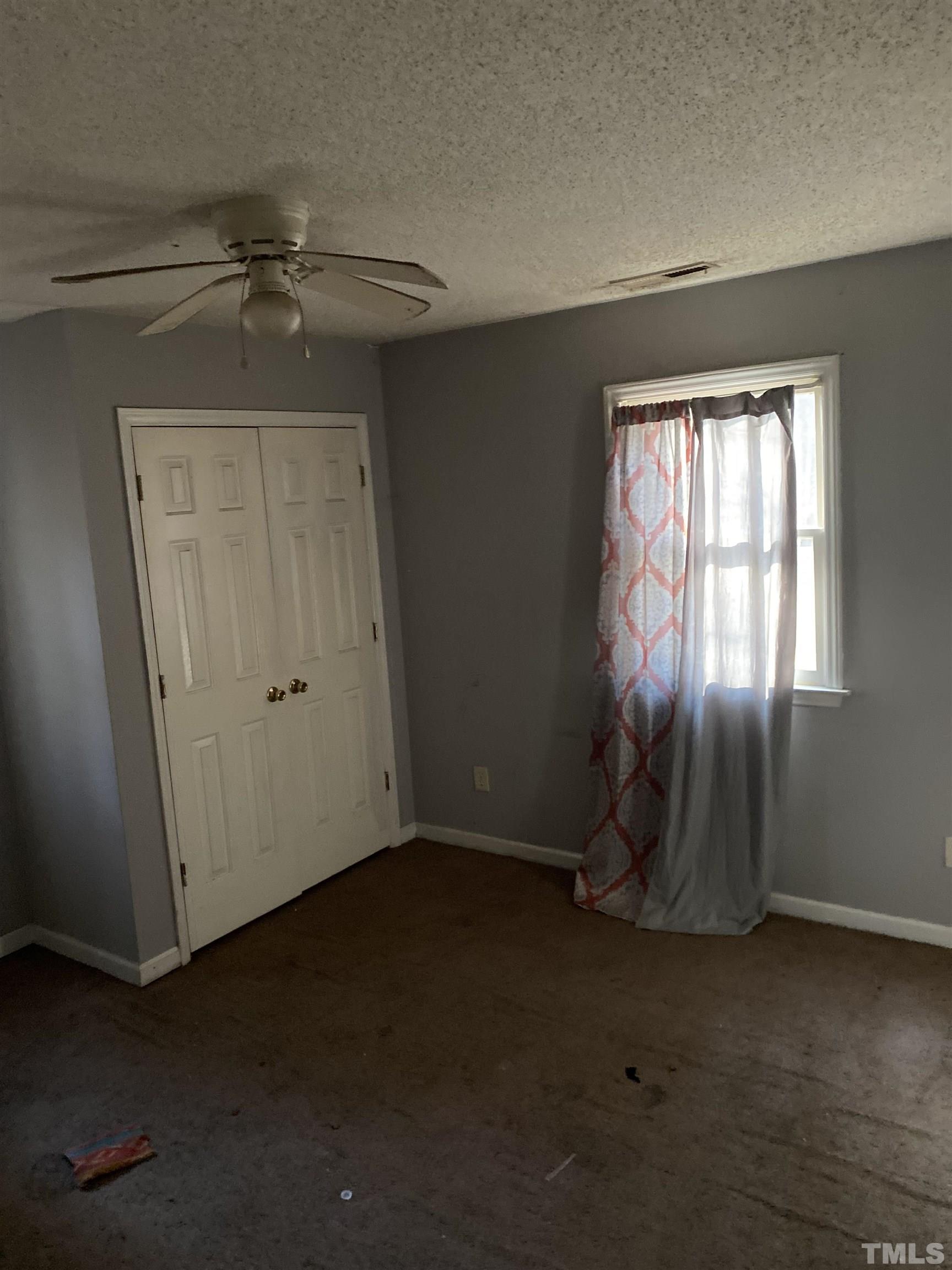2428 Keith Drive Raleigh, NC 27610 - Photo 17 of 24 an empty room with windows and fan