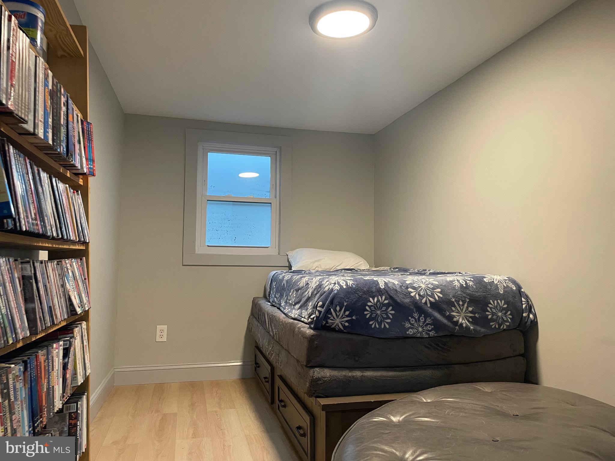8 Ranger Road Falling Waters, WV 25419 - Photo 13 of 23 a bed sitting in a bedroom next to a book shelf