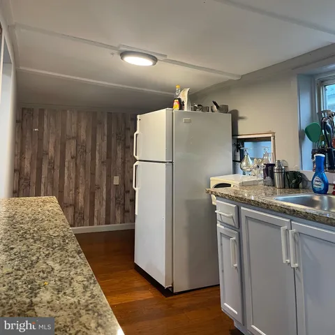 a kitchen with a refrigerator and a sink