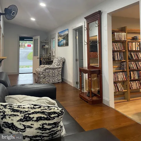 a bedroom with furniture and a book shelf