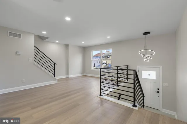 a view of entryway with stairs and wooden floor