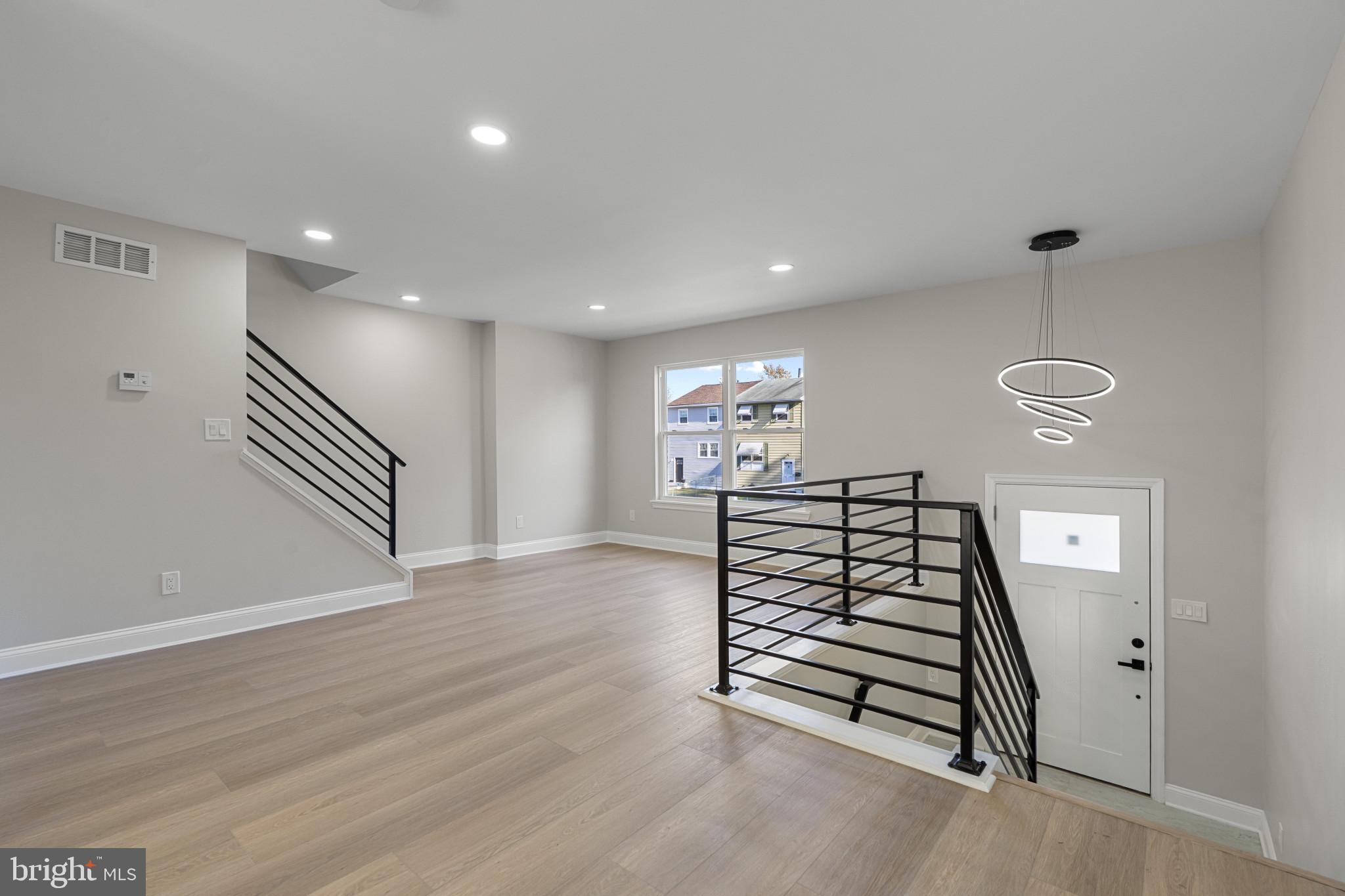 a view of entryway with stairs and wooden floor