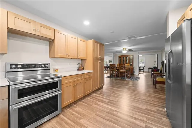 a kitchen with wooden floors and stainless steel appliances