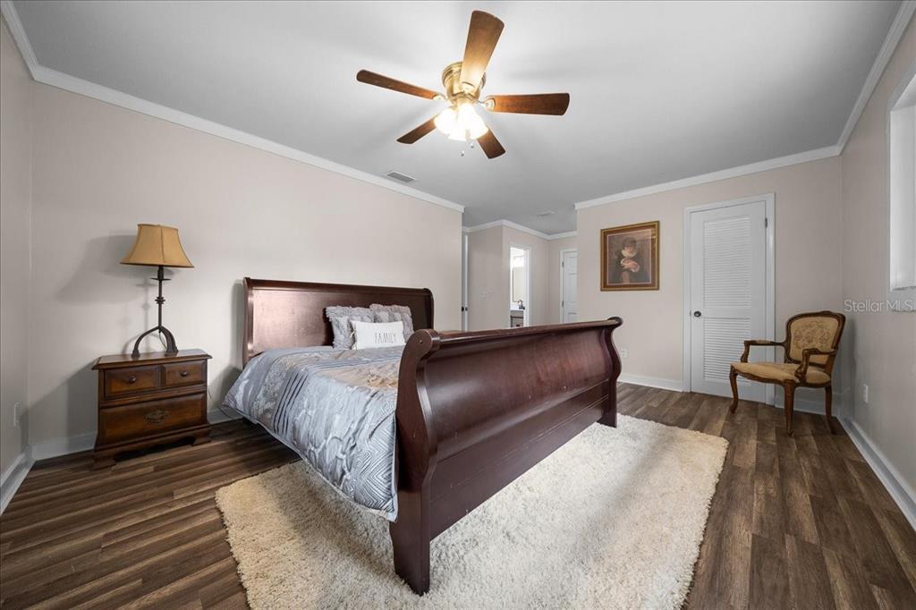 7380 Southwest 86th Lane Ocala, FL 34476 - Photo 15 of 50 a bedroom with bed and a chandelier