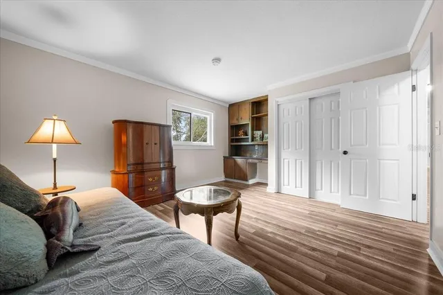 a bedroom with a bed and a lamp on table