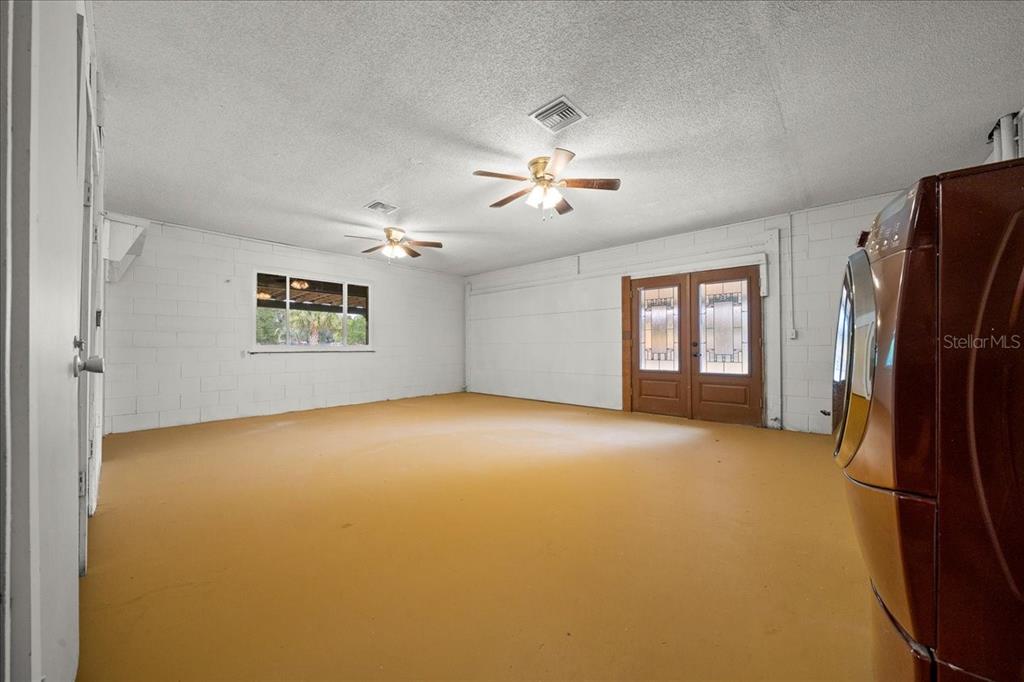 7380 Southwest 86th Lane Ocala, FL 34476 - Photo 24 of 50 a view of a livingroom with a refrigerator a ceiling fan and windows