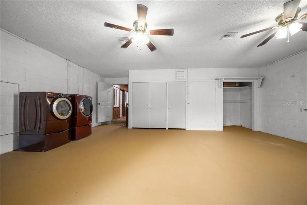 7380 Southwest 86th Lane Ocala, FL 34476 - Photo 25 of 50 a view of a livingroom with a chandelier fan and kitchen view