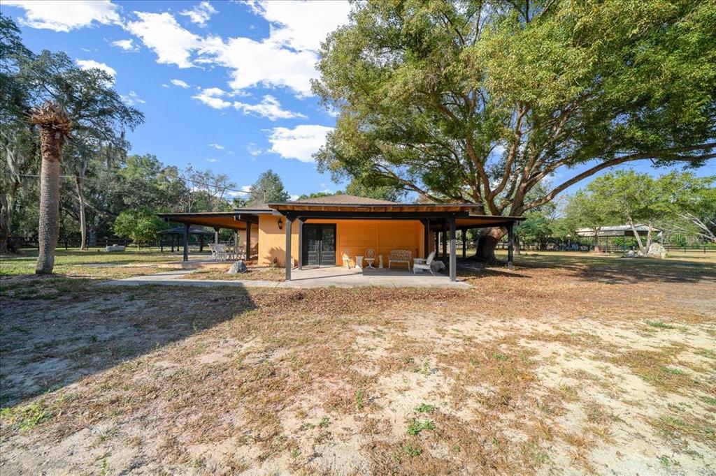 7380 Southwest 86th Lane Ocala, FL 34476 - Photo 27 of 56 a front view of a house with a yard and trees