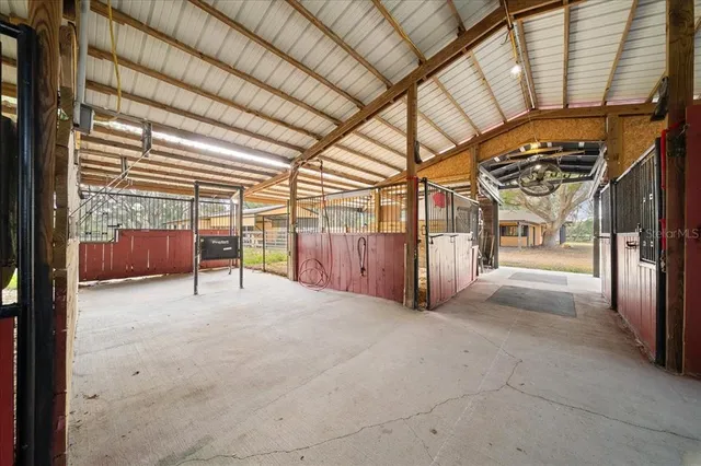 a view of a porch with a door and wooden floor