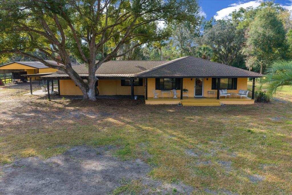 7380 Southwest 86th Lane Ocala, FL 34476 - Photo 41 of 56 a blue house with trees in front of it