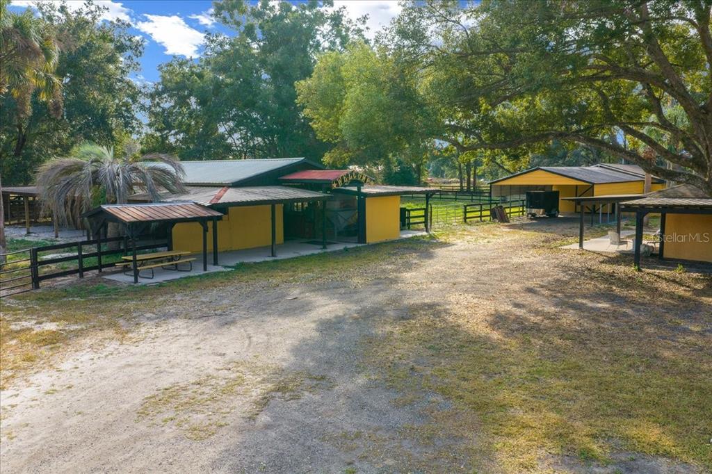 7380 Southwest 86th Lane Ocala, FL 34476 - Photo 42 of 56 a view of a patio with a table and chairs under an umbrella