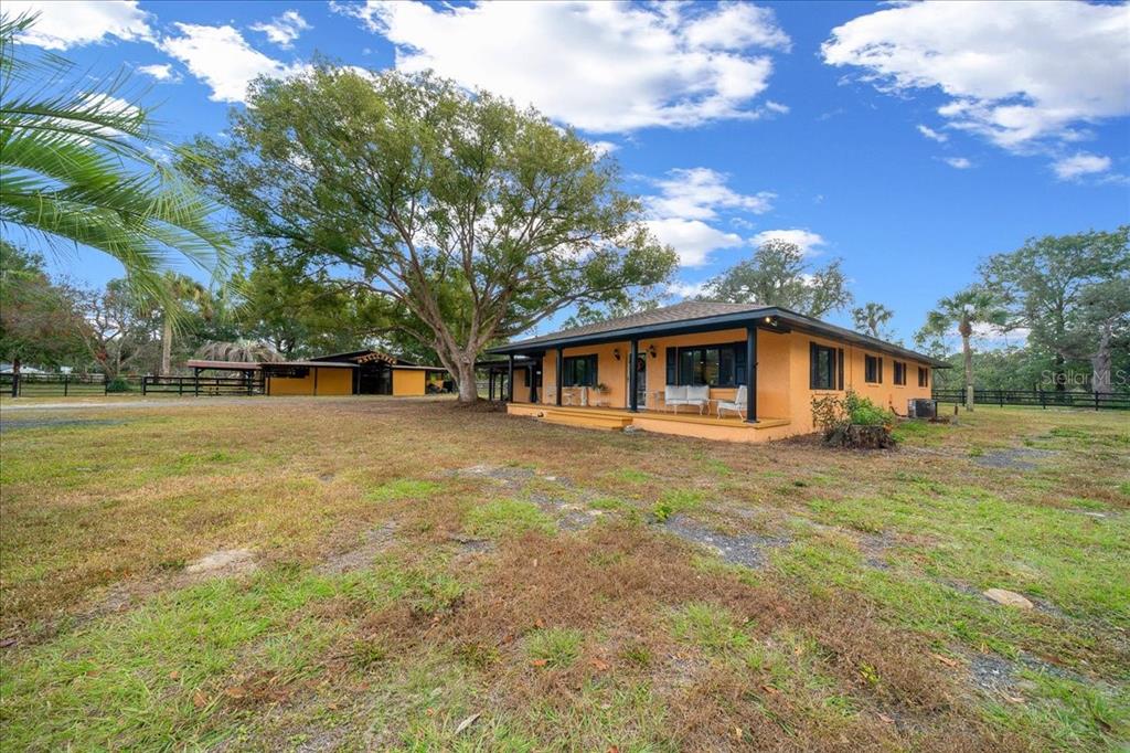 7380 Southwest 86th Lane Ocala, FL 34476 - Photo 5 of 56 a front view of a house with a garden