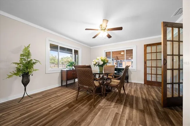 a view of a dining room with furniture window and wooden floor