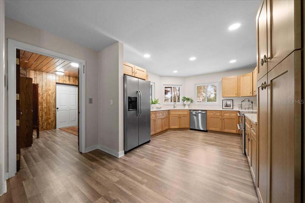 7380 Southwest 86th Lane Ocala, FL 34476 - Photo 10 of 50 a view of a kitchen with stainless steel appliances refrigerator a sink and wooden floor