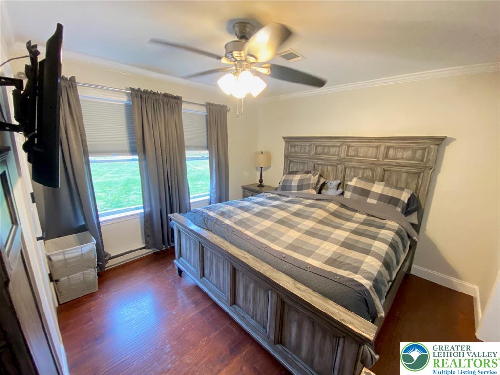 4571 Newburg Road Nazareth, PA 18064 - Photo 13 of 29 a bedroom with a bed and a flat tv screen on a dresser