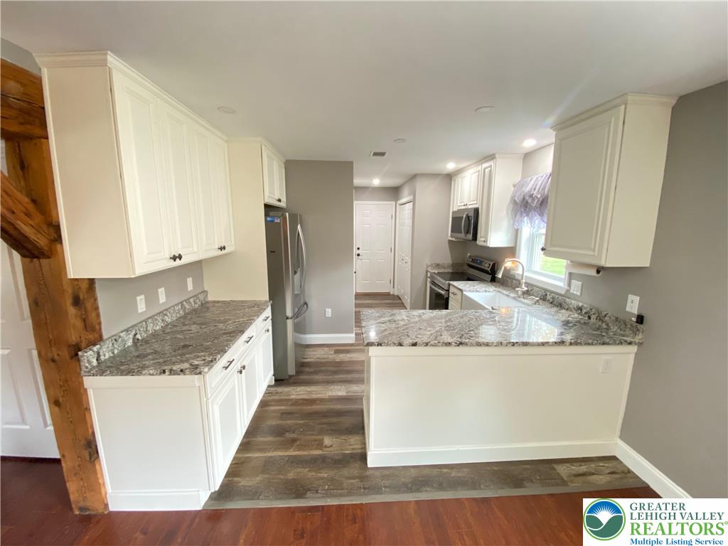 4571 Newburg Road Nazareth, PA 18064 - Photo 4 of 29 a large kitchen with kitchen island granite countertop a large counter top and stainless steel appliances