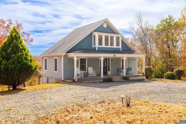 a front view of a house with a yard covered in snow