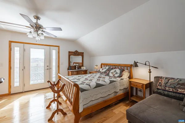 a living room with furniture a flat screen tv and kitchen view
