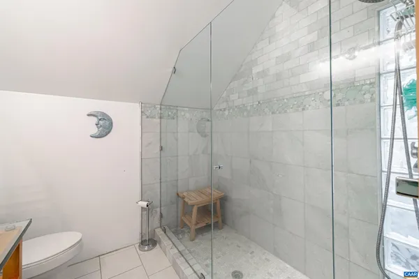 a living room with furniture a flat screen tv and a large window