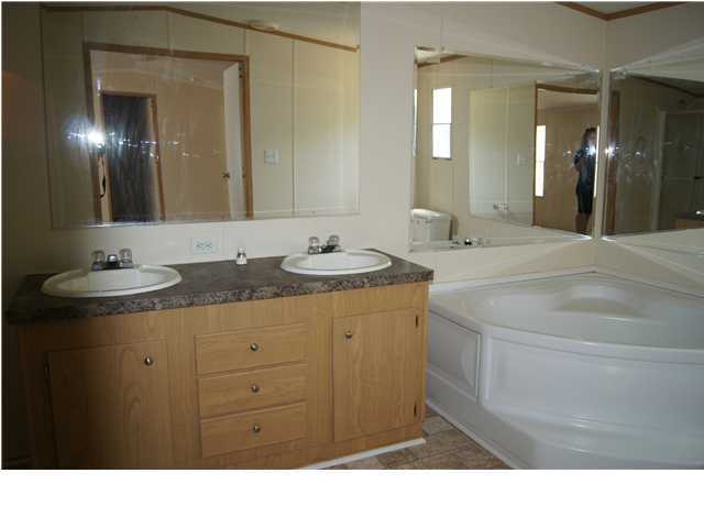 4305 Rebecca Road Crestview, FL 32539 - Photo 12 of 20 a bathroom with a sink double vanity and a mirror