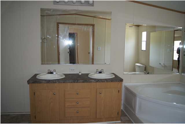 4305 Rebecca Road Crestview, FL 32539 - Photo 13 of 20 a bathroom with a sink double vanity and a mirror
