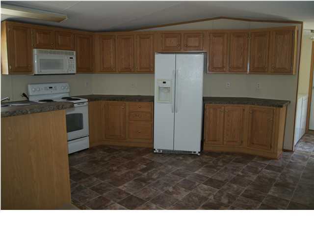 4305 Rebecca Road Crestview, FL 32539 - Photo 4 of 20 a kitchen with a refrigerator and a stove