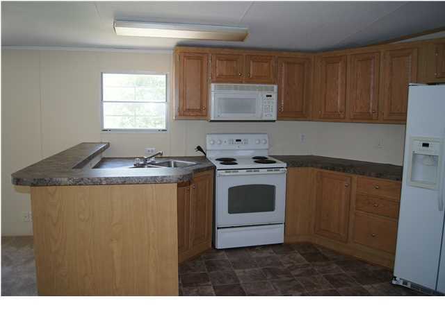 4305 Rebecca Road Crestview, FL 32539 - Photo 5 of 20 a kitchen with a stove sink and cabinets