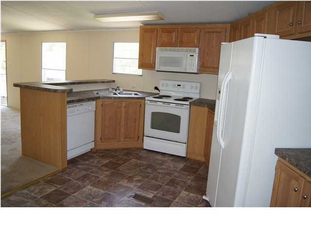 4305 Rebecca Road Crestview, FL 32539 - Photo 6 of 20 a kitchen with stainless steel appliances a refrigerator sink and stove