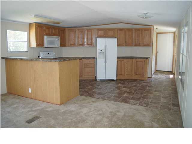 4305 Rebecca Road Crestview, FL 32539 - Photo 7 of 20 a kitchen with a refrigerator and a cabinets