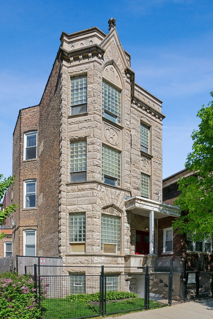 a front view of a residential apartment building with a yard