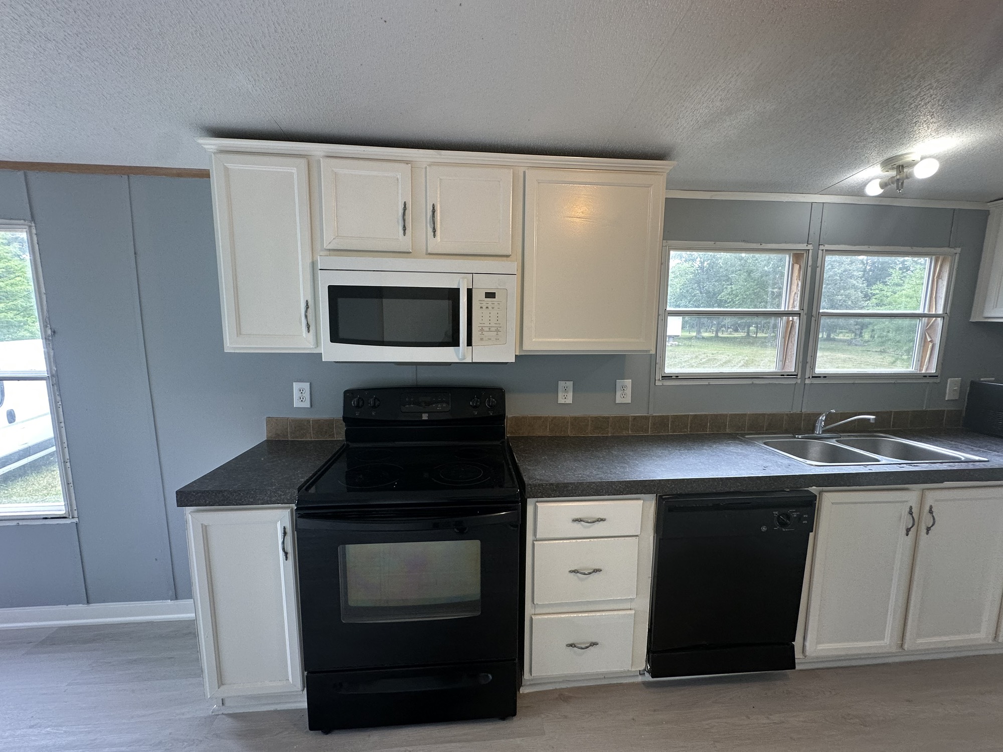 2229 Meekins Road Cleveland, TX 77328 - Photo 7 of 48 a kitchen with a sink stove and microwave