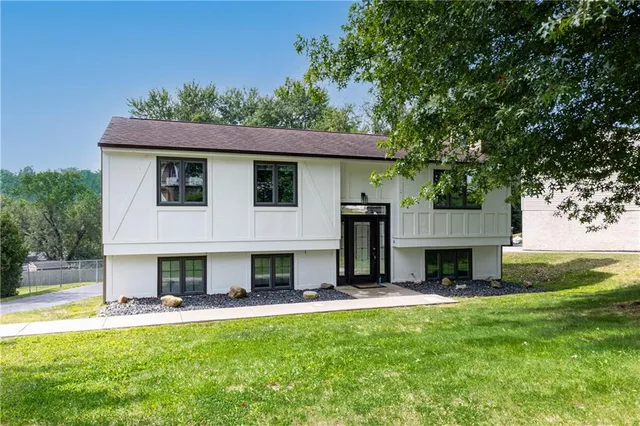 a view of house with yard and outdoor seating