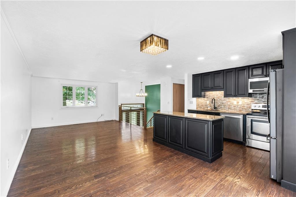 230 Dodd Drive Washington, PA 15301 - Photo 13 of 49 a kitchen with stainless steel appliances granite countertop a refrigerator a stove top oven a sink and dishwasher with wooden floor