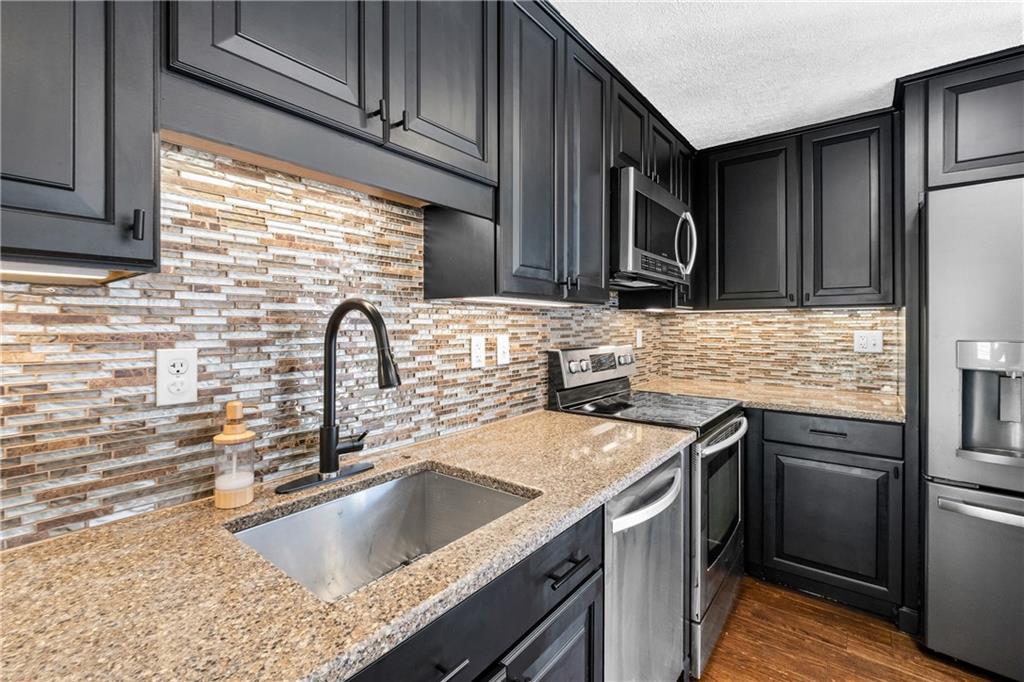 230 Dodd Drive Washington, PA 15301 - Photo 14 of 49 a kitchen with granite countertop a sink stainless steel appliances and cabinets