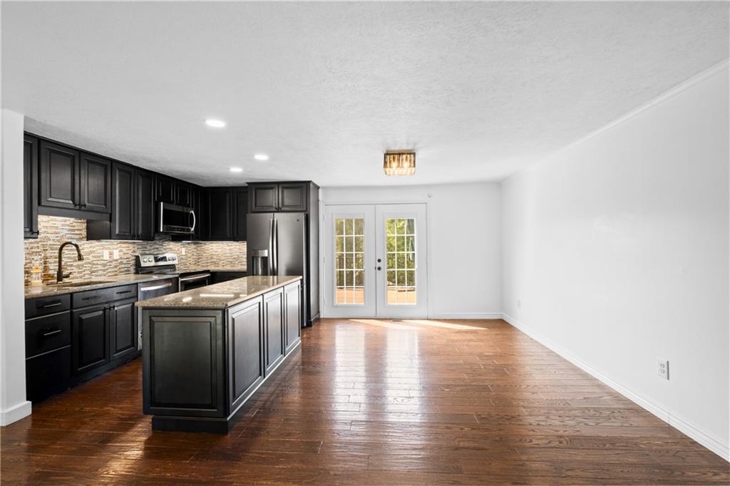 230 Dodd Drive Washington, PA 15301 - Photo 16 of 49 a kitchen with stainless steel appliances granite countertop a stove a sink and a refrigerator