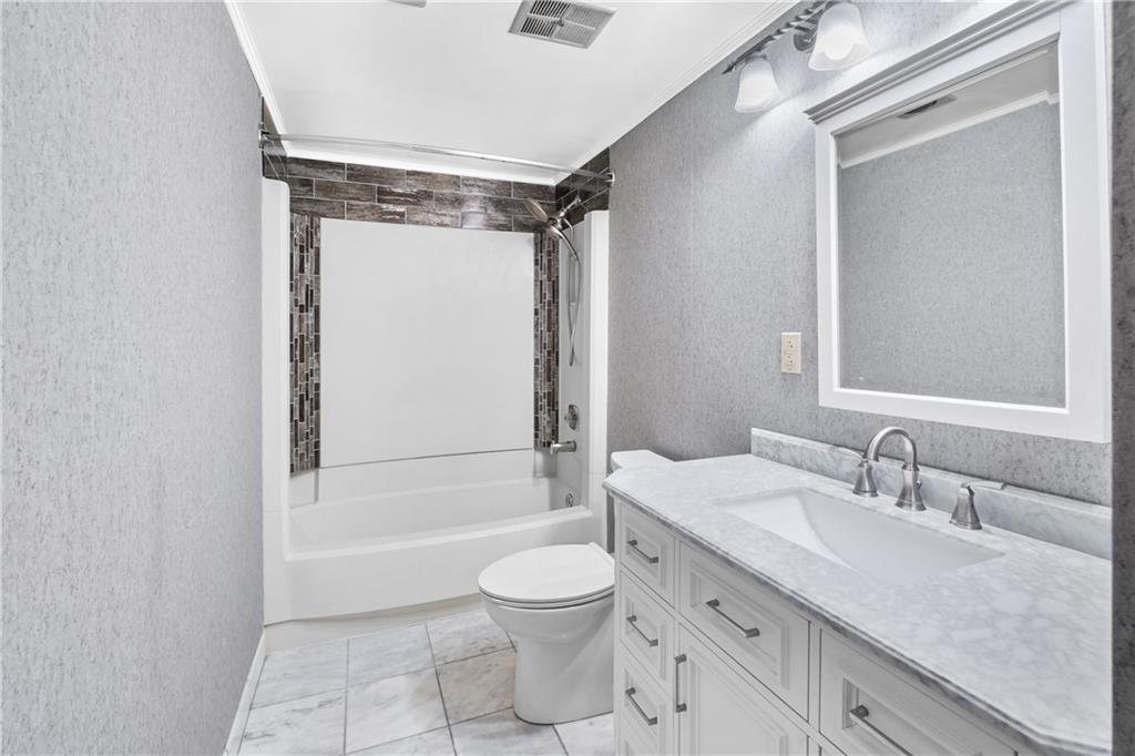 230 Dodd Drive Washington, PA 15301 - Photo 22 of 49 a bathroom with a granite countertop sink toilet a mirror and shower