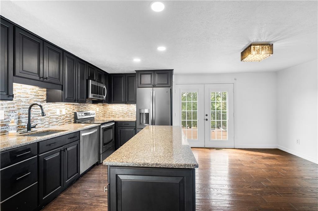 230 Dodd Drive Washington, PA 15301 - Photo 4 of 49 a kitchen with stainless steel appliances granite countertop a sink stove and oven