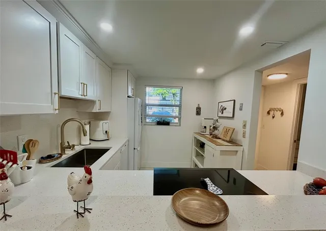 a kitchen with a sink cabinets and appliances