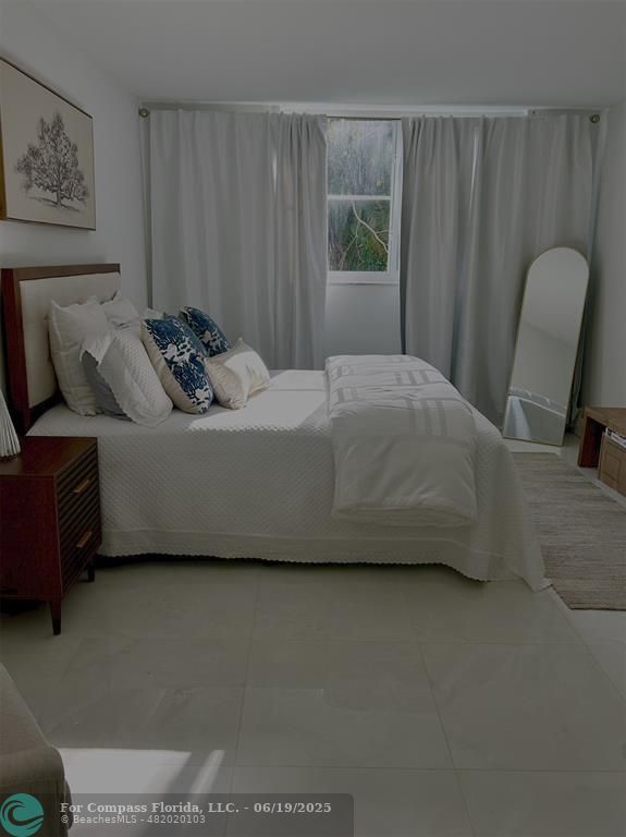 3060 Holiday Springs Boulevard, Unit 102 Margate, FL 33063 - Photo 12 of 12 a living room with furniture and a window